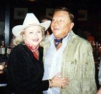 Barbara Taylor Bradford dons a cowboy while visiting a Texas watering hole with husband, Bob Bradford