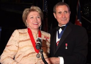 English screen/stage actor Jim Dale presents Barbara with her medal