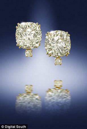 A pair of old-cut yellow diamond single-stone earrings. Estimated worth: £53,000-£66,000