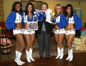 Barbara Taylor Bradford is presented with an autographed boot from the Dallas Cowboys Cheerleader squad at the Lupton Ranch in Dallas, Texas