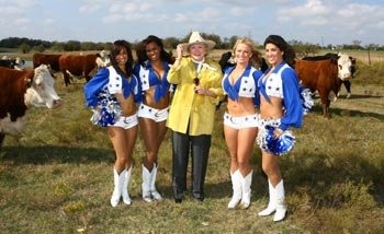 Barbara Taylor Bradford and the Dallas Cowboys Cheerleaders get up-close and personal with the cattle at the Lupton Ranch in Dallas, Texas