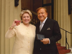 Barbara Taylor Bradford showing her OBE with Robert Bradford
